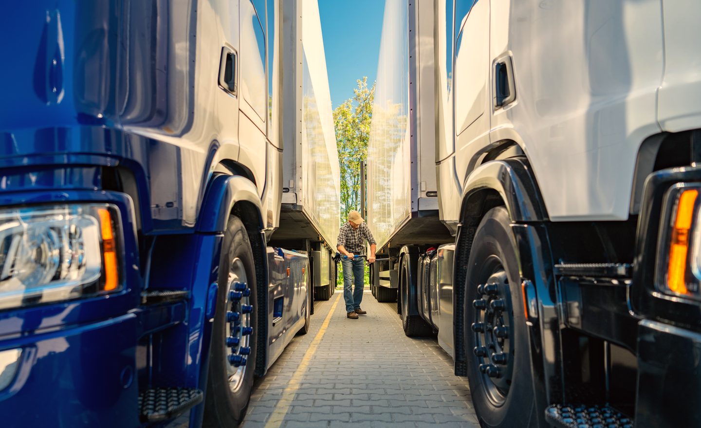 Driver walking between parked trucks